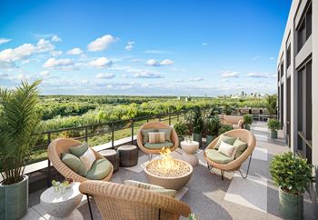 a terrace with wicker chairs and a fire pit at Lilia, Lilydale